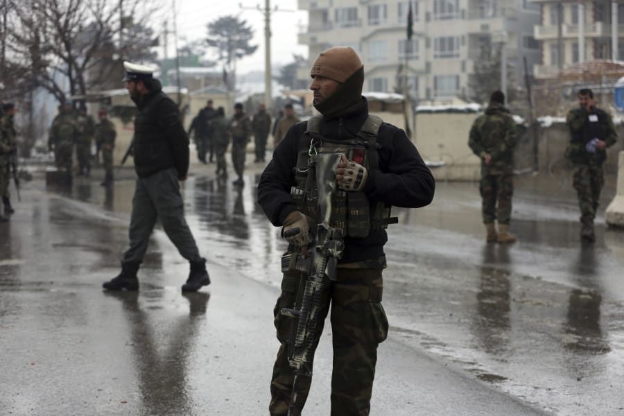 National army soldiers stand guard at the site of suicide attack near the military academy in Kabul, Afghanistan, Tuesday, Feb. 11, 2020. A suicide bomber targeting a military academy in the Afghan capital on Tuesday killed at least six people, including two civilians and four military personnel, the Interior Ministry said.