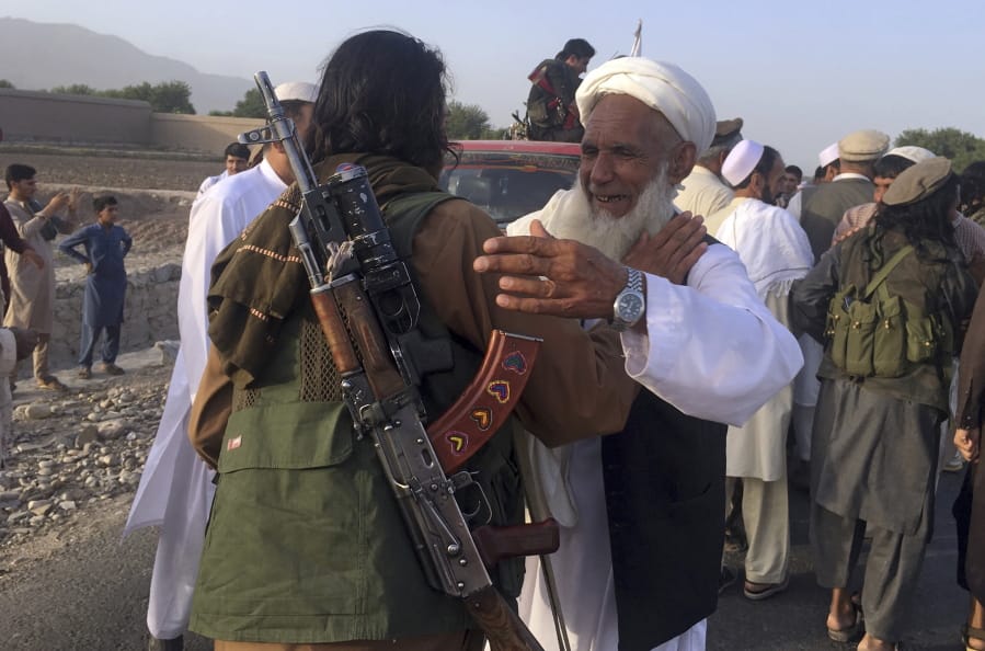 FILE - In this June 16, 2018 file photo, Taliban fighters gather with residents to celebrate a three-day cease fire marking the Islamic holiday of Eid al-Fitr, in Nangarhar province, east of Kabul, Afghanistan. Many Afghans view Saturday&#039;s expected signing of a U.S.-Taliban peace deal with a heavy dose of well-earned skepticism. They&#039;ve spent decades living in a country at war -- some their whole lives -- and wonder if they can ever reach a state of peace.
