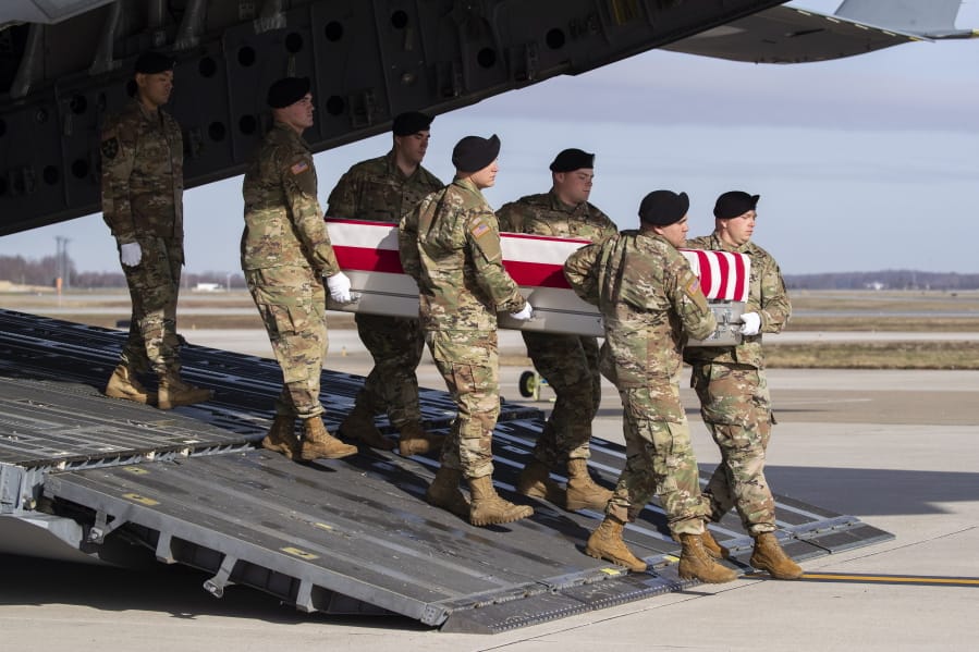 FILE - In this Dec. 25, 2019, file photo, an Army carry team moves a transfer case containing the remains of U.S. Army Sgt. 1st Class Michael Goble at Dover Air Force Base, Del. Goble, a U.S. Special Forces soldier who died in Afghanistan in December 2019.