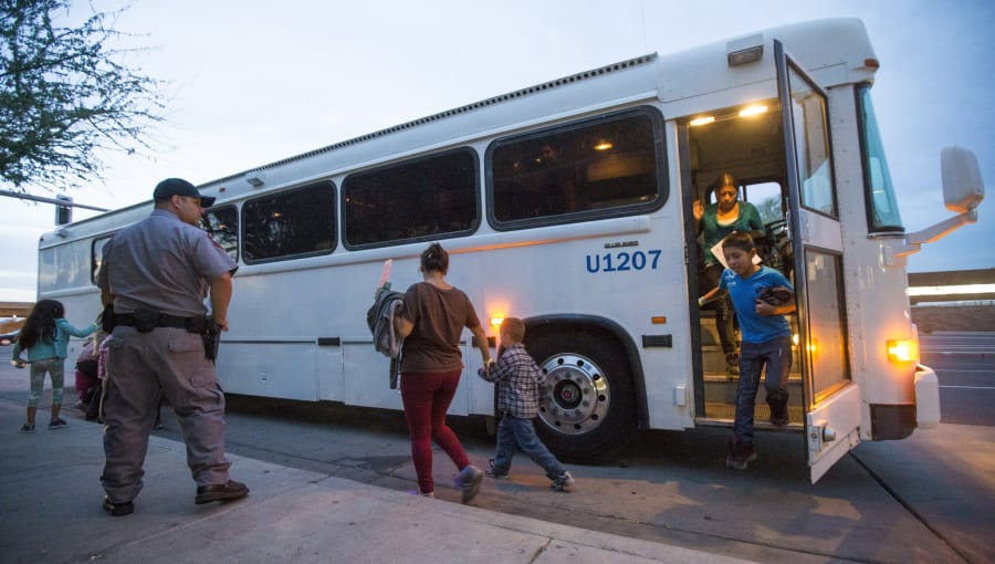 Migrants are released from ICE custody at a Greyhound bus station May 28, 2014, in Phoenix.