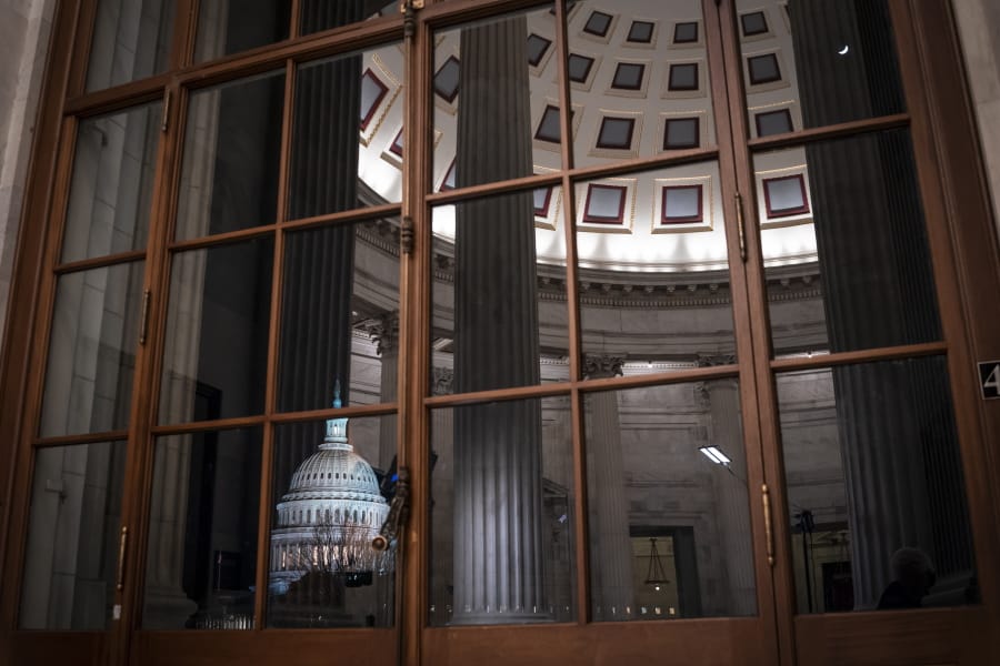 The Capitol is seen amid reflections of the Russell Senate Office Building in Washington last month. (j.