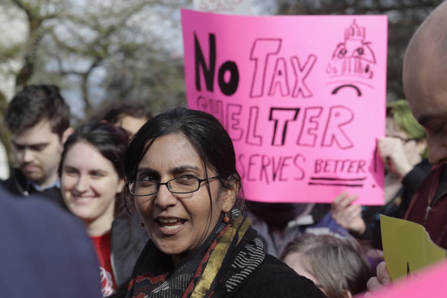 Seattle city councilmember Kshama Sawant talks about her proposal for a tax on large businesses that she says would raise $300 million to build thousands of new homes in Seattle and retrofit existing homes as she appears at a rally Wednesday at the Capitol in Olympia. (Ted S.