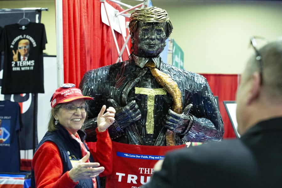 A supporter of President Trump poses for a photo next to a figure during Conservative Political Action Conference, CPAC 2020, at the National Harbor, in Oxon Hill, Md., Thursday, Feb. 27, 2020.