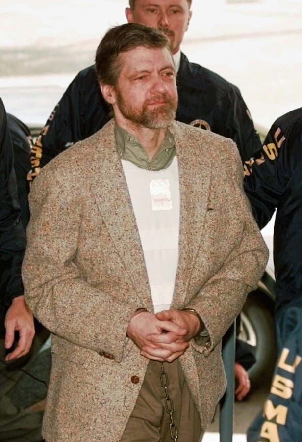 FILE-- In this June 21, 1997 file photo is Theodore Kaczynski, the convicted Unabomber who is serving a life sentence in a federal prison in Colorado for carrying out a series of mail bombings that killed three people. A federal grand jury in San Francisco indicted Vladislav Victorvic Timoshchuk, on charges of of mailing two envelopes containing ricin to Pelican Bay State Prison, officials announced on Friday Feb. 21, 2020. Last year the federal Bureau of Prisons intercepted a Christmas card from Timoshchuk, now living in Belarus, to Kaczynski, in which authorities say Timoshchuk discussed his plan to mail ricin to the United States.