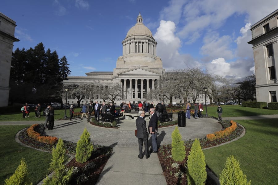 People gather at the sundial in front of the Legislative Building, Monday, Feb. 3, 2020, at the Capitol in Olympia. (AP Photo/Ted S.