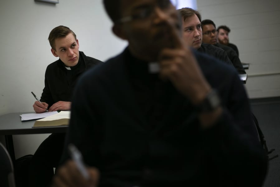 Seminarian Daniel Rice, left, sits with classmates during a lesson Feb. 5 on the Gospel of Luke at St. Charles Borromeo Seminary in Wynnewood, Pa. Future Catholic priests remain unflinchingly optimistic despite scandals that have driven faithful from the pews.