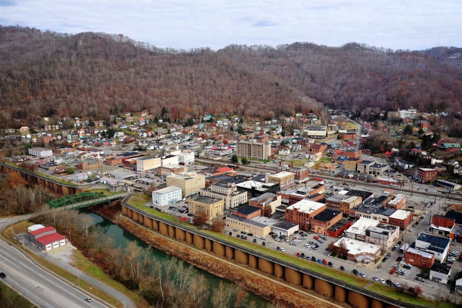FILE- In this Thursday, Nov. 29, 2018 photo Williamson, W.Va., is seen across the border from Kentucky. West Virginia relies the most of any U.S. state on federal money that is guided by the once-a-decade census, according to a new update of a long-running study. Federal funding represents more than 16% of the personal income in West Virginia, according to an update released this week to the study led by Andrew Reamer at George Washington University.