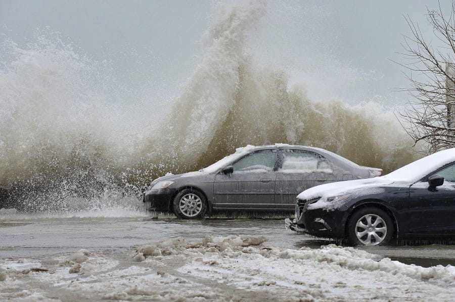 Large Lake Michigan waves crash against the lakefront, Thursday, Feb. 13, 2020, causing erosion and ice formation near East 72th Street in Chicago.