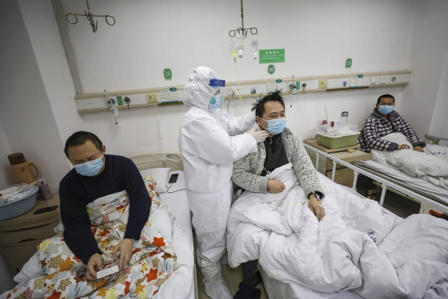 A doctor checks the conditions of a patient in Jinyintan Hospital, designated for critical COVID-19 patients, in Wuhan in central China&#039;s Hubei province Thursday, Feb. 13, 2020. China on Thursday reported 254 new deaths and a spike in virus cases of 15,152.