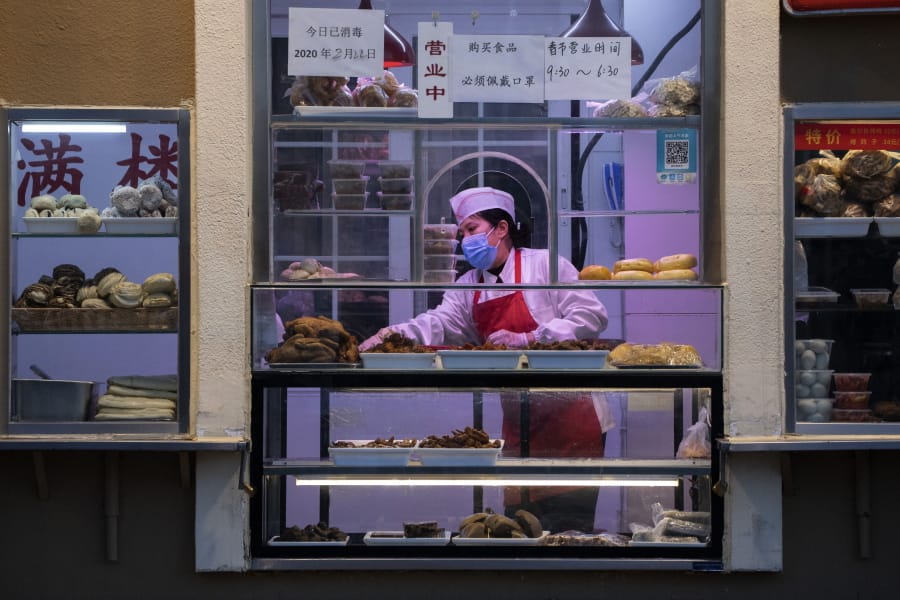 A chef works near display of food products Feb. 22 at a restaurant in Beijing.