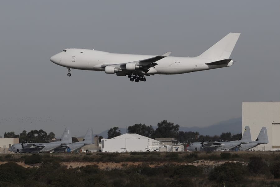 A plane carrying evacuees from the virus zone in China lands at Marine Corps Air Station Miramar Wednesday, Feb. 5, 2020, in San Diego. One of two jets carrying Americans fleeing the virus zone in China landed Wednesday morning at Miramar after first landing at an Air Force base in Northern California. Some will be quarantined at a hotel on the base for 14 days while others will be quarantined at a Southern California military base, officials said.