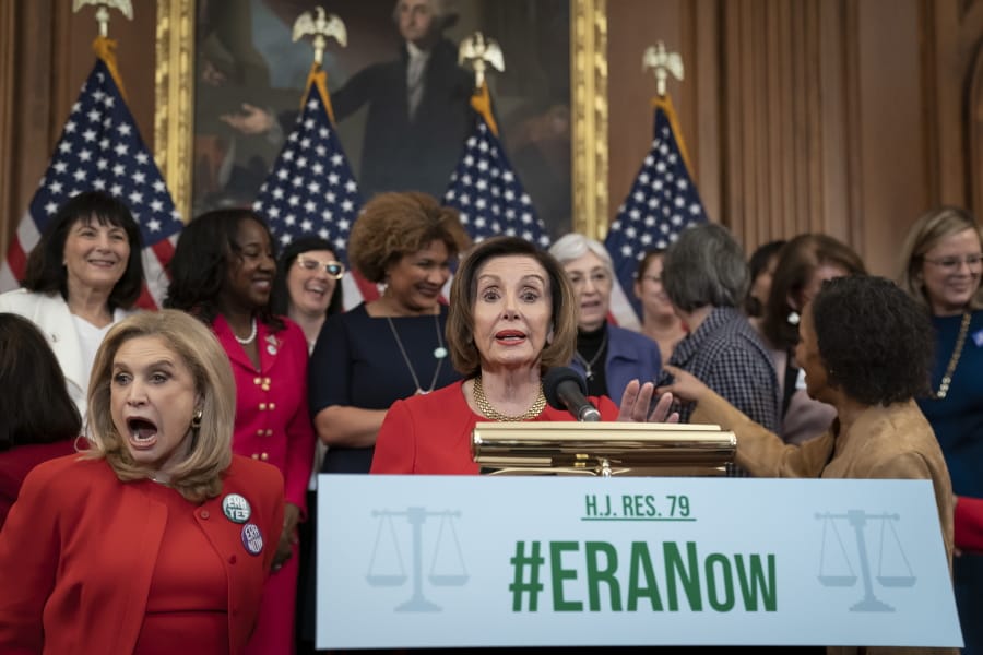 Speaker of the House Nancy Pelosi, D-Calif., joined at left by Rep. Carolyn Maloney, D-N.Y., and other congressional Democrats, holds an event about their resolution to remove the deadline for ratification of the Equal Rights Amendment, at the Capitol in Washington, Wednesday, Feb. 12, 2020. (AP Photo/J.