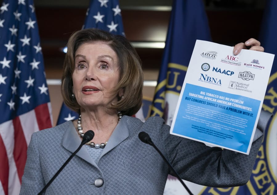 Speaker of the House Nancy Pelosi, D-Calif., displays an advocacy ad that criticizes the tobacco and vaping industry for allegedly targeting young African-Americans, during a news conference on Capitol Hill in Washington, Thursday, Feb. 27, 2020.  (AP Photo/J.