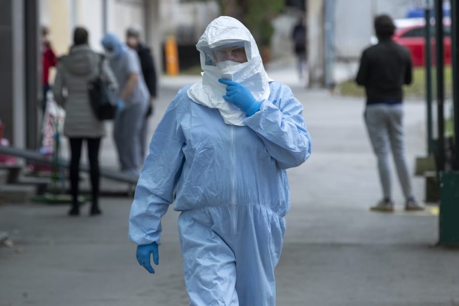 A health worker wears protective suit at the infectious disease clinic in Zagreb, Croatia, where the first coronavirus case in Croatia is hospitalized, Tuesday, Feb. 25, 2020. Croatia confirmed its first case of coronavirus in a man who had been to Milan, the capital of Lombardy, Italy.