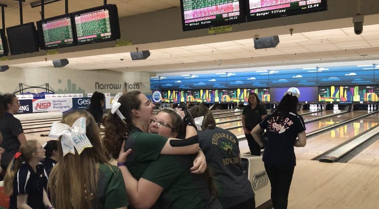 Evergreen's Karina Johnson (left) and Kierra Wilcox celebrate the team's monster fifth game Friday at the 3A state bowling tournament. The Plainsmen rolled a 1,004-pin fifth game and have a 167-pin team lead entering Saturday.
