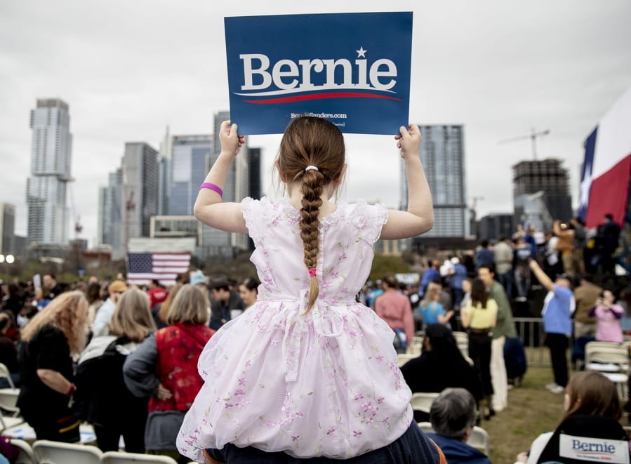 Lily Barbour, 5, holds up a campaign sign for Democratic presidential candidate Sen. Bernie Sanders, I-Vt., during a campaign event in Austin, Texas, Sunday, Feb. 23, 2020.