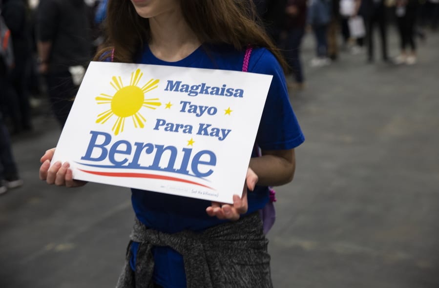 Olivia Knight, 13, holds a sign in Tagalog, a language from the Philippine Islands, meaning &quot;Let&#039;s Unite for Bernie&quot; during a Democratic presidential candidate U.S. Sen. Bernie Sanders, I-Vt., rally at the Mesquite Arena, Friday, Feb. 14, 2020, in Mesquite, Texas.