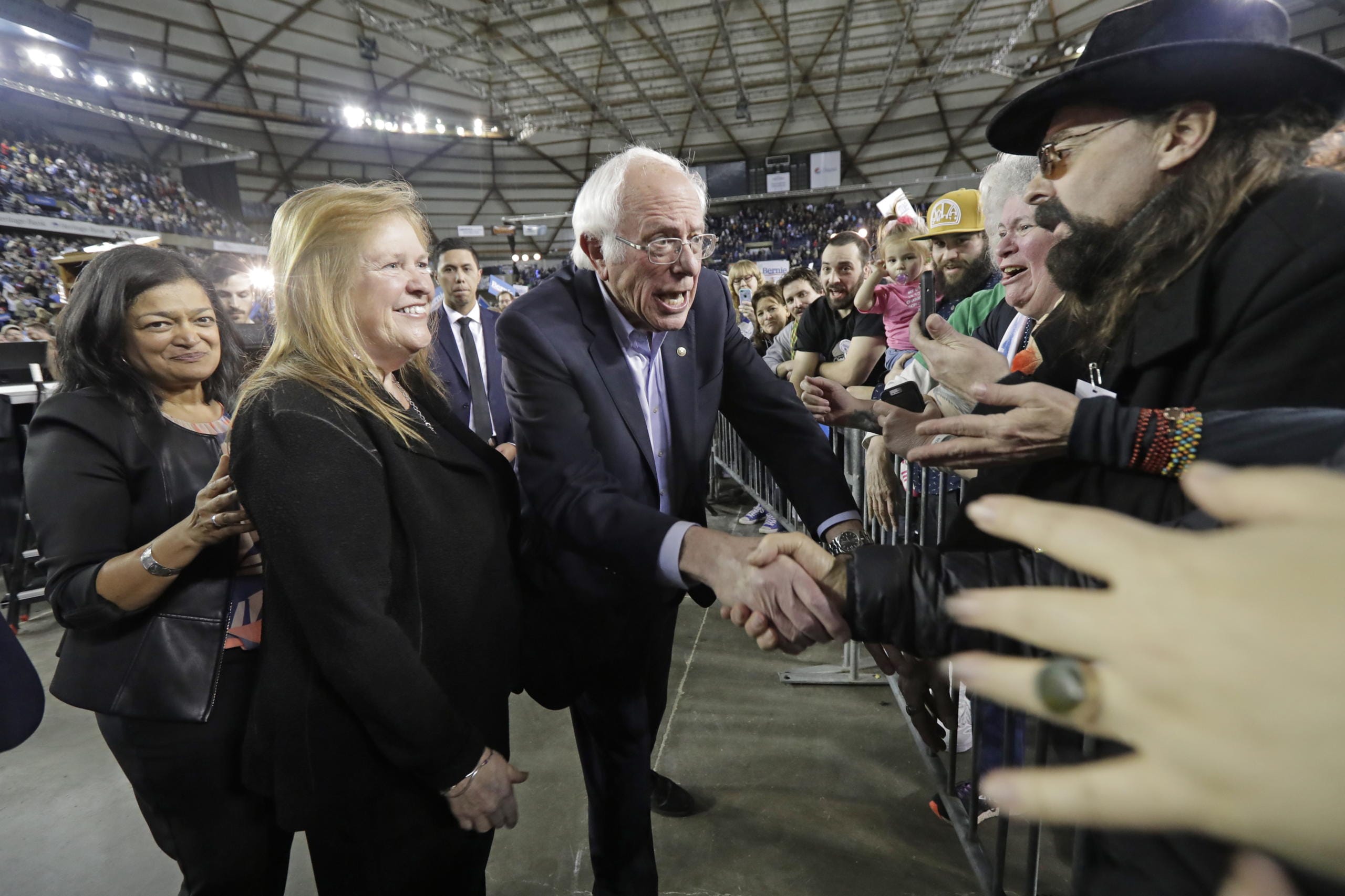 Democratic presidential candidate Sen. Bernie Sanders I-Vt., center, shakes hands along with his wife Jane, second from left, and U.S. Rep. Pramila Jayapal (D-Wash.), left, after his speech at a campaign event in Tacoma, Wash., Monday, Feb. 17, 2020. (AP Photo/Ted S.