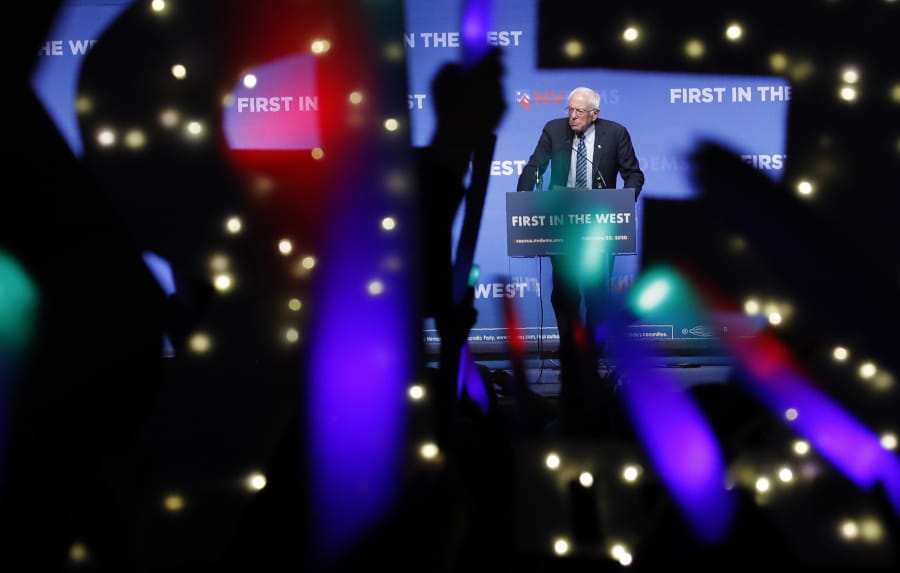 FILE - In this Sunday, Nov. 17, 2019 file photo, Democratic presidential candidate Sen. Bernie Sanders, I-Vt., speaks as supporters wave lighted signs during a fundraiser for the Nevada Democratic Party in Las Vegas. During the 2020 campaign, Sanders, who&#039;s known more for eschewing organized religion than embracing his Jewishness, has shifted the way he talks about his faith and tied it to his broader worldview.