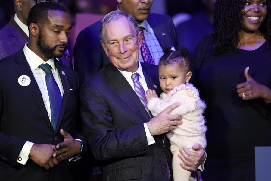 Democratic presidential candidate and former New York City Mayor Michael Bloomberg is joined on stage by supporters during his campaign launch of &quot;Mike for Black America,&quot; at the Buffalo Soldiers National Museum, Thursday, Feb. 13, 2020, in Houston. (AP Photo/David J.