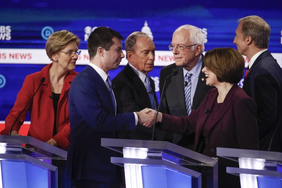 From left, Democratic presidential candidates, Sen. Elizabeth Warren, D-Mass., former South Bend Mayor Pete Buttigieg, former New York City Mayor Mike Bloomberg, Sen. Bernie Sanders, I-Vt., Sen. Amy Klobuchar, D-Minn., and businessman Tom Steyer, greet on another on stage at the end of the Democratic presidential primary debate at the Gaillard Center, Tuesday, Feb. 25, 2020, in Charleston, S.C., co-hosted by CBS News and the Congressional Black Caucus Institute.