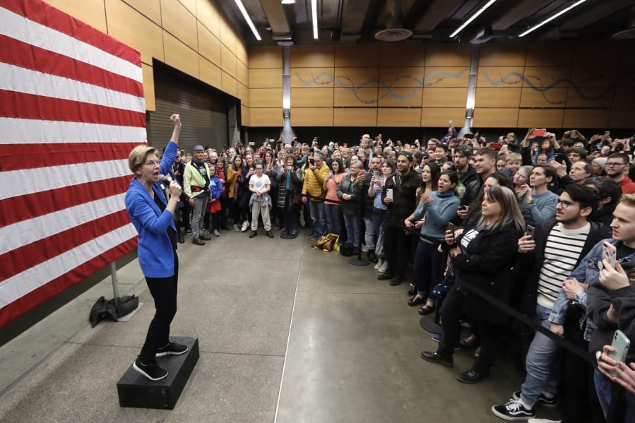 Democratic presidential candidate U.S. Sen. Elizabeth Warren, D-Mass., addresses an overflow crowd before addressing a larger rally during a campaign event Saturday in Seattle.