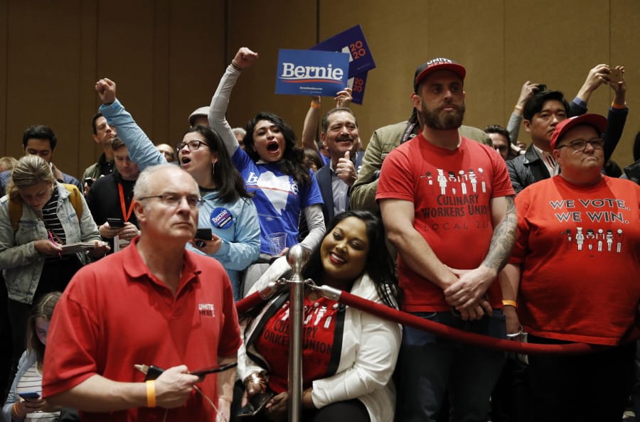 Supporters of Democratic presidential candidate Sen. Bernie Sanders, I-Vt., cheer as members of the Culinary Workers Union watch during a Democratic presidential caucus at the Bellagio hotel-casino, Saturday, Feb. 22, 2020, in Las Vegas.