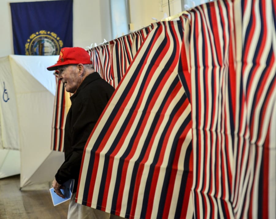 William J. Patenaude, a Korean and Vietnam veteran and resident of Chesterfield, N.H., leaves the voting booth with his ballot in hand at the Chesterfield, N.H., Polling Station inside the Town Hall during the New Hampshire presidential primary elections, Tuesday, Feb. 11, 2020.