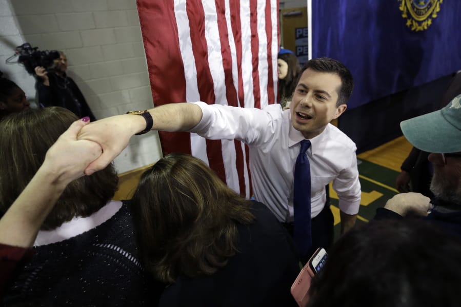 Democratic presidential candidate former South Bend, Ind., Mayor Pete Buttigieg, center right, greets people in the audience at the conclusion of a campaign rally, Sunday, Feb. 9, 2020, in Dover, N.H.