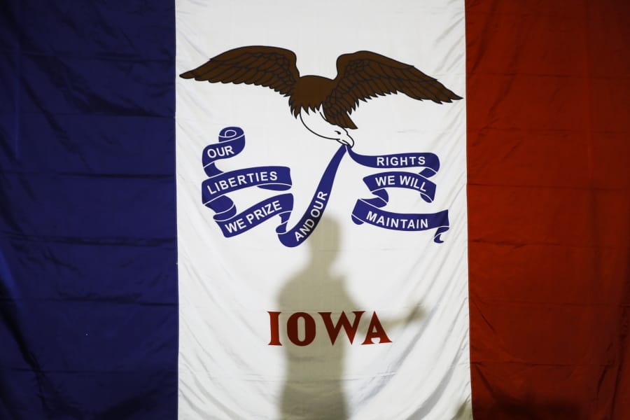 Democratic presidential candidate former South Bend, Ind., Mayor Pete Buttigieg&#039;s shadow is cast on the Iowas state flag as he speaks during a campaign event at Northwest Junior High, Sunday, Feb. 2, 2020, in Coralville, Iowa.