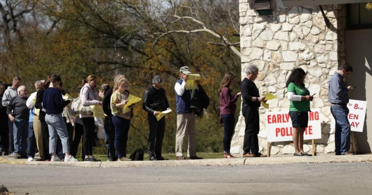 Voters wait in line at an early polling site in San Antonio, Friday, Feb. 28, 2020. Friday is the final day for early voting and Election Day is Tuesday.