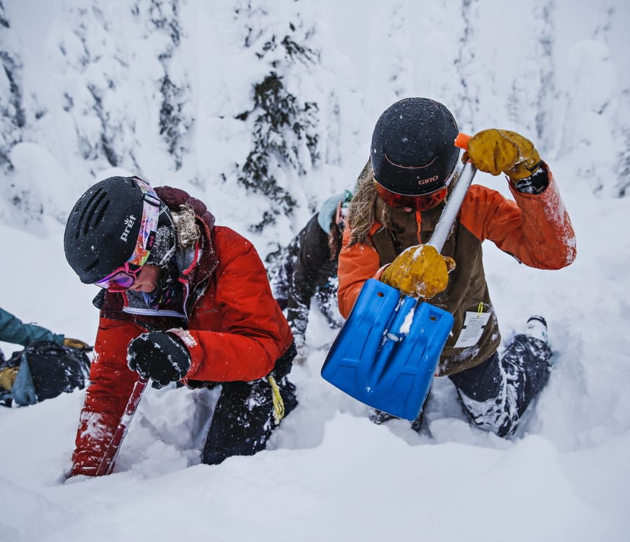 Madison Browning, left, and Sarah Schmidt practice their digging speed and technique during a ladies Level 1 avalanche course at Whitefish Mountain Resort on Jan. 31.