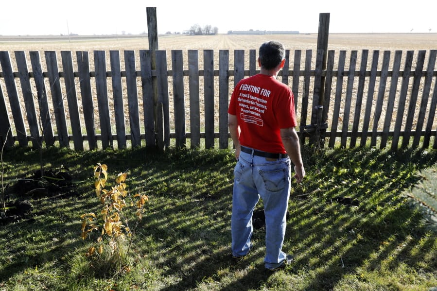 In this Oct. 29, 2018, photo, Jeff Schwartzkopf, of Rudd, Iowa, looks at the concentrated animal feeding operation, or CAFO, built near his home in Rudd, Iowa. Jeff and Gail Schwartzkopf say their lives changed drastically after a hog operation was built a quarter-mile from their home in northern Iowa.
