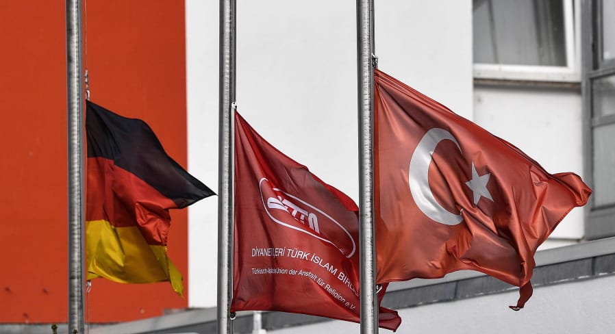 German and Turkish flags hanging half-mast in front of a mosque after the shooting in Hanau, Germany, Friday, Feb. 21, 2020. A 43-year-old German man shot and killed several people of foreign background, most of them Turkish, on Wednesday night in an attack that began at a hookah bar.