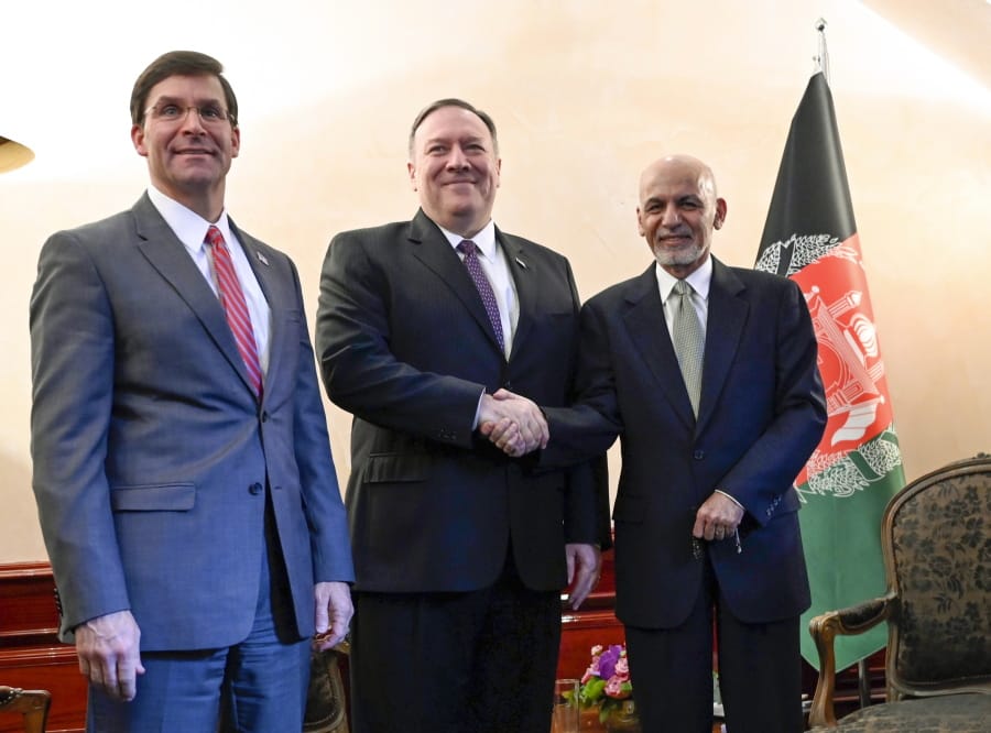 US Secretary of State Mike Pompeo, center, shakes hands with Afghan President Ashraf Ghani, right, as US Secretary of Defense Mark Esper watches during the 56th Munich Security Conference (MSC) in Munich, southern Germany, on Friday, Feb. 14, 2020. The 2020 edition of the Munich Security Conference (MSC) takes place from Feb. 14 to 16.