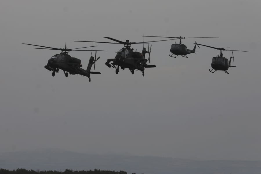 Helicopters take part in a military drill in Litochoro, northern Greece, on Wednesday, Feb. 19, 2020. Army aviation forces from Greece and the United States are taking part in a live-fire exercise with attack helicopters, marking deepening defense ties between the two countries.