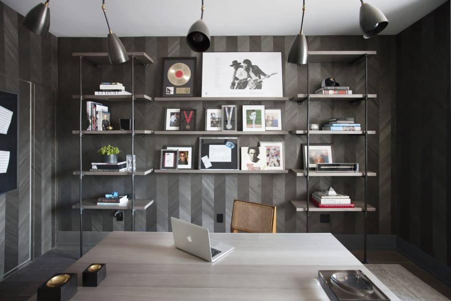 A home office designed by interior designer Michelle Gerson in New York. When one partner has a collection to display and the other partner prefers an uncluttered space, it&#039;s important to take an organized approach, as seen in this home office space created by Gerson, where custom shelving was designed to prominently but neatly display a collection of music memorabilia.