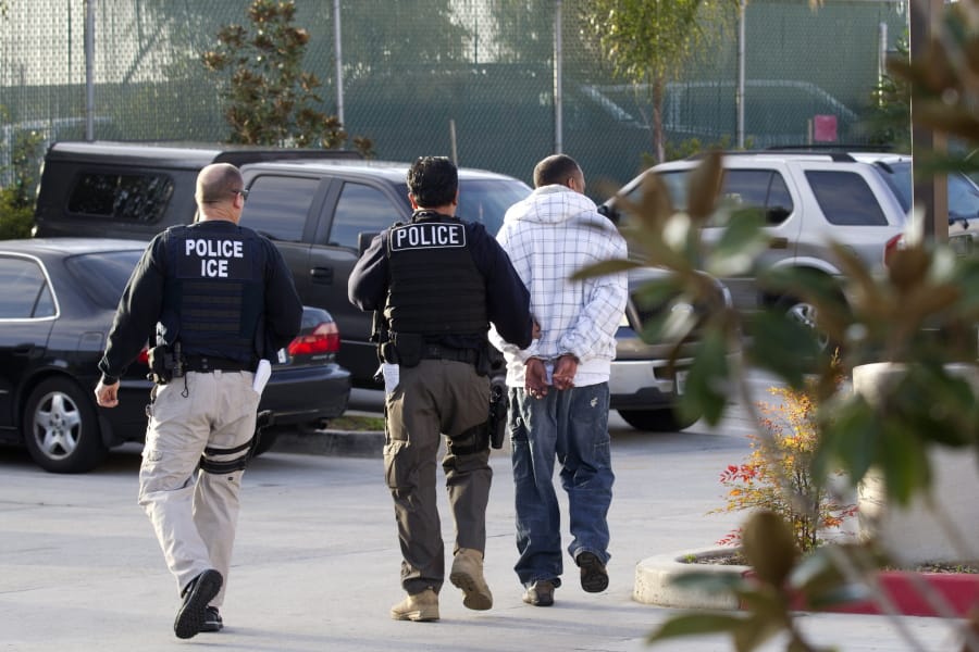 FILE - In this March 30, 2012 file photo, Immigration and Customs Enforcement (ICE) agents take a suspect into custody as part of a nationwide immigration sweep in Chula Vista, Calif. San Diego County Sheriff Bill Gore says he will comply with U.S. Immigration and Customs Enforcement&#039;s request for information on four people with criminal records, becoming the first state or local law enforcement official in the country to so honor such requests among a spate of jurisdictions whose laws sharply restrict cooperation with immigration authorities.