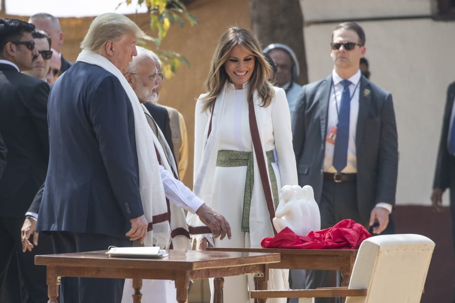 U.S. President Donald Trump, with first lady Melania Trump, look at a gift from Indian Prime Minister Narendra Modi, as they tour Gandhi Ashram, Mondayin Ahmedabad, India.
