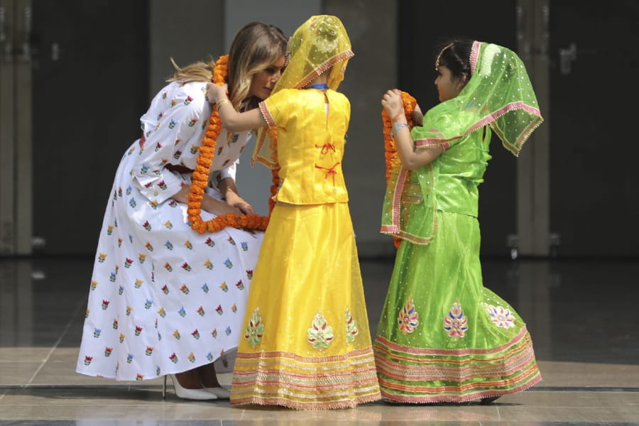U.S. first lady Melania Trump is garlanded by two children at Sarvodaya Co-Educational Senior Secondary School in New Delhi, India, Tuesday, Feb. 25, 2020.