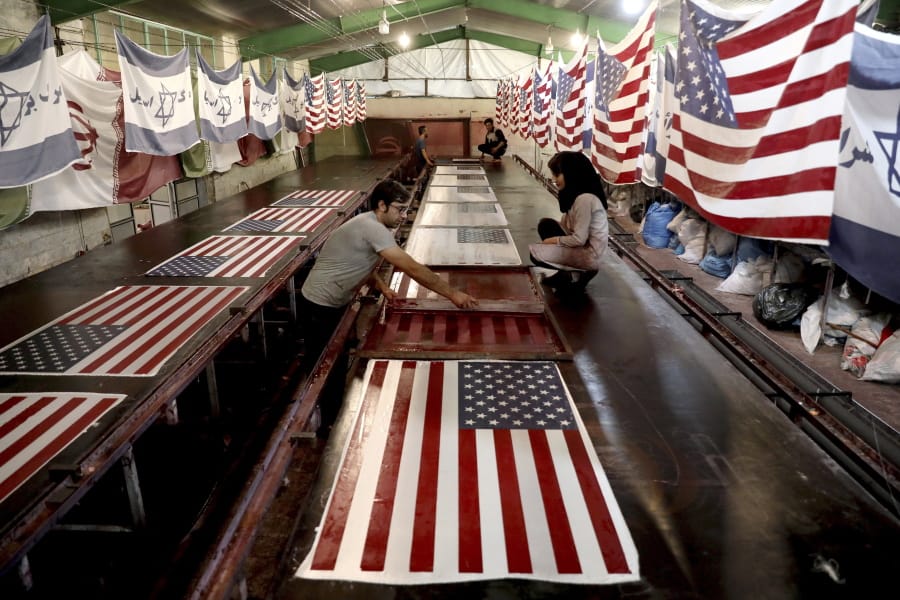 Workers print U.S. flags using a silkscreen at the Diba Parcham Khomein factory in Heshmatieh village, a suburb of Khomein city, in central Iran.