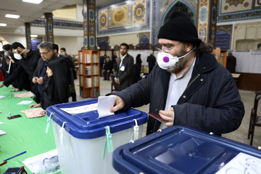 A voter casts his ballot in the parliamentary elections in a polling station in Tehran, Iran, Friday, Feb. 21, 2020. Iranians began voting for a new parliament Friday, with turnout seen as a key measure of support for Iran&#039;s leadership as sanctions weigh on the economy and isolate the country diplomatically.