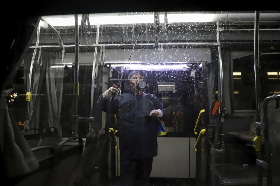 A worker disinfects a public bus against coronavirus in the city of Ahvaz in southwestern, Iran, in early morning of Tuesday, Feb. 25, 2020. Iran&#039;s government said Tuesday that more than a dozen people had died nationwide from the new coronavirus, rejecting claims of a much higher death toll of 50 by a lawmaker from the city of Qom that has been at the epicenter of the virus in the country.