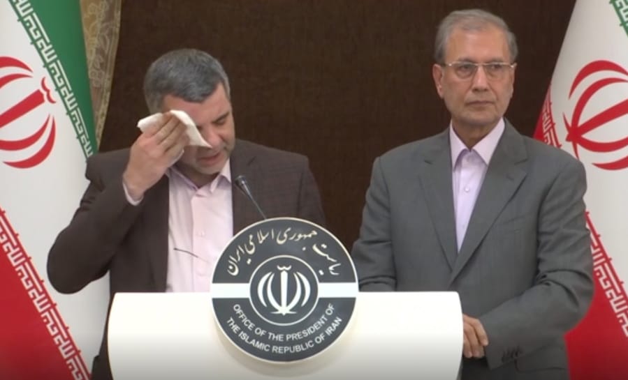 In this Monday Feb. 24, 2020 image made from video the head of Iran&#039;s counter-coronavirus task force, Iraj Harirchi, left, wipes his face during a press briefing with government spokesman Ali Rabiei, in Tehran, Iran. Harirchi, has tested positive for the virus himself, authorities announced Tuesday, amid concerns the outbreak may be far wider than officially acknowledged. The announcement regarding Harirchi came after the news conference seeking to minimize the danger posed by the outbreak.