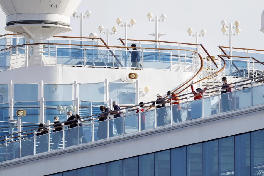Passengers stand on the deck of the Diamond Princess cruise ship anchored at Yokohama Port in Yokohama, near Tokyo, Wednesday, Feb. 12, 2020. Japan&#039;s health ministry said Wednesday that 39 new cases of a virus have been confirmed on the cruise ship quarantined at the Japanese port.