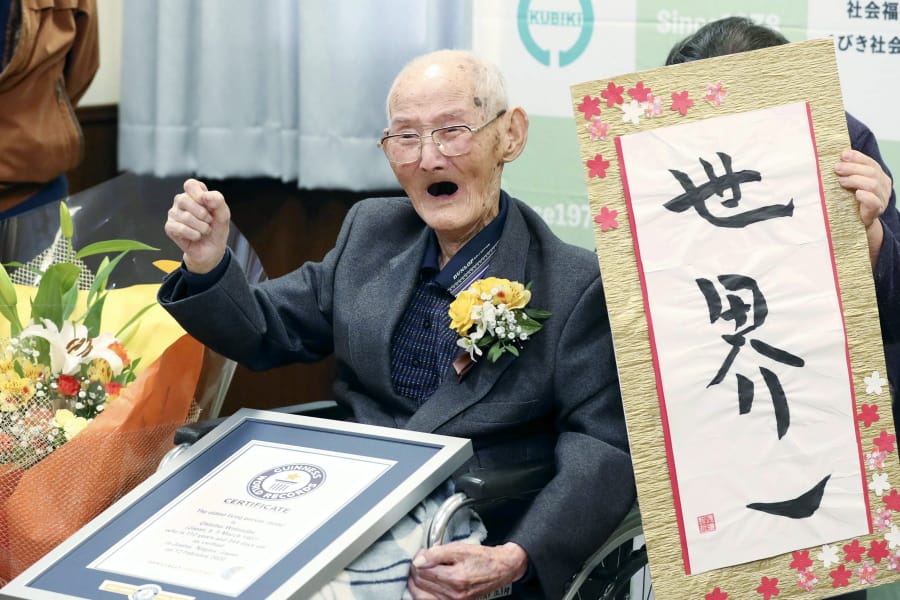 Chitetsu Watanabe, 112, sits next to the calligraphy he wrote after being awarded a certificate for being the world&#039;s oldest living male Wednesday in Joetsu, Japan.
