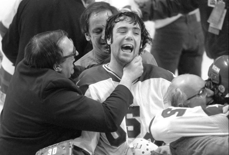 In this Feb. 22, 1980, photo, Team USA goaltender Jim Craig got a hug from goalie coach Warren Strelow in the moments after defeating the Soviet Union during the medal-round of the Winter Olympics in Lake Placid, N.Y. Tourism is a $1.2 billion industry in the Lake Placid region, much of it still fueled by the memory of the U.S. hockey team beating the Soviet Union as the &quot;Miracle on Ice&quot; highlight of the 1980 Olympic Games.