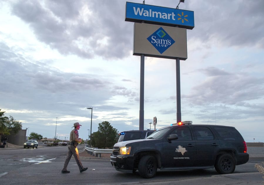 FILE - In this Aug. 4, 2019 file photo, a Texas State Trooper walks back to his car while providing security outside the Walmart store in the aftermath of a mass shooting in El Paso, Texas. A gunman who said he was targeting Mexicans and killed 22 people at a Walmart store in El Paso, Texas, over the summer has been indicted on federal hate crimes charges, a person familiar with the matter told The Associated Press.