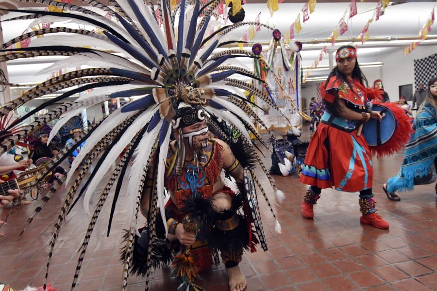 In this Jan. 24, 2020 photo, people in Aztec clothing take part in a dance at the Sagrado Corazon de Jesus church in Minneapolis for a two-day celebration of St. Paul, the patron saint of their Mexican hometown of Axochiapan and nearby villages in the state of Morelos. The celebration is a way to recognize their roots and feel closer to the families and home they left behind.
