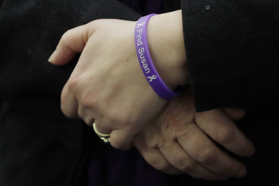 Denise Ernest, the sister of missing Utah woman Susan Cox Powell, wears a bracelet that reads &quot;Find Susan,&quot; Tuesday, Feb. 18, 2020, during a break in a session of Pierce County Superior Court in Tacoma, Wash., on the first day of a civil lawsuit over the murder of the Susan&#039;s two young sons Charlie and Braden, who were attacked and killed by their father Josh Powell in 2012 while he was under suspicion for Susan Powell&#039;s disappearance. The parents of Susan Cox Powell allege that negligence by the Washington state Department of Social and Health Services was a contributing factor that led to the deaths of their grandsons. (AP Photo/Ted S.